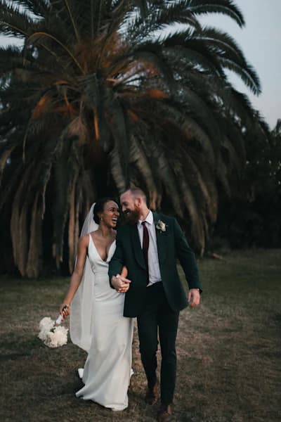 Happy wedding couple sharing a romantic first dance on a beautifully lit dance floor